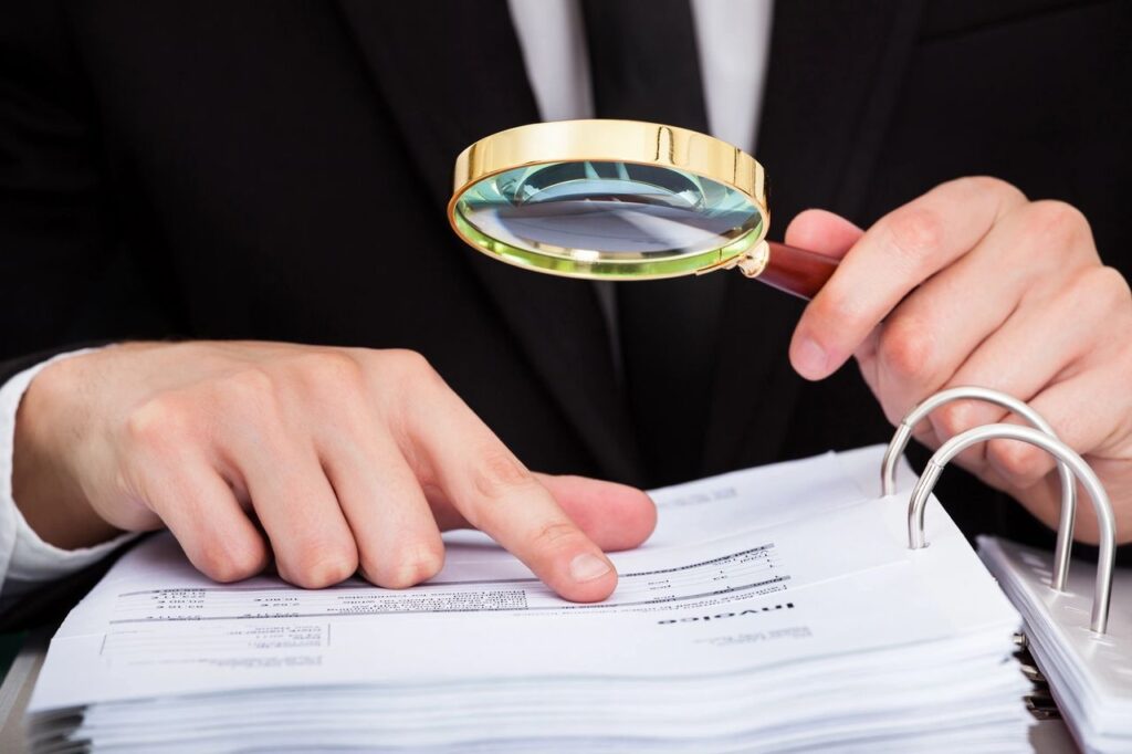 image of a hands holding a magnifying glass representing looking closer or studying something closely