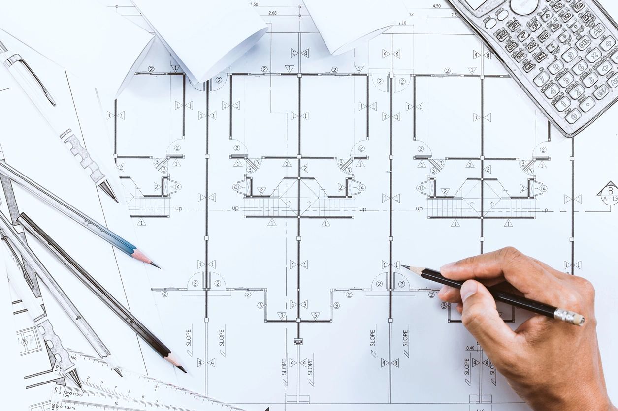 Architectural drawing ink on white paper with a hand holding a sketch pencil. architect at work