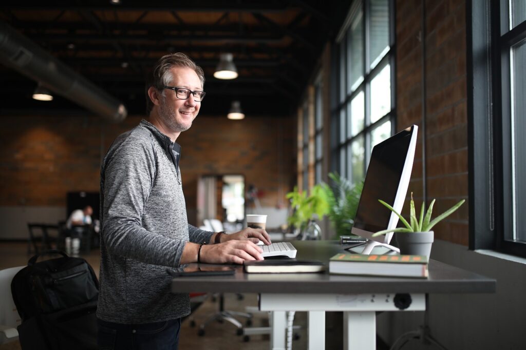 Person sitting at a desk in an office. Nice environment. At the office